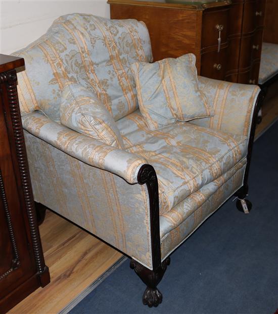 A pair of blind fret-carved mahogany bergeres and a matching stool